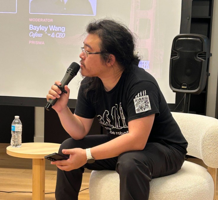 Bayley Wang speaking into a microphone