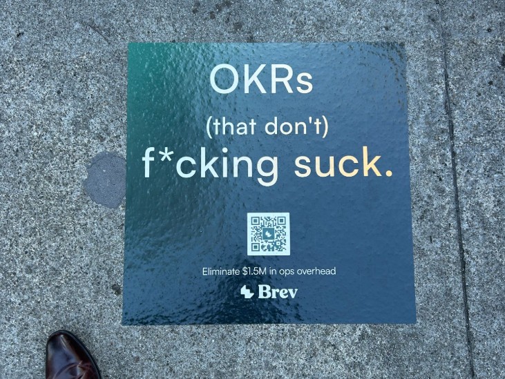 A Brev advertising sticker on a San Francisco sidewalk