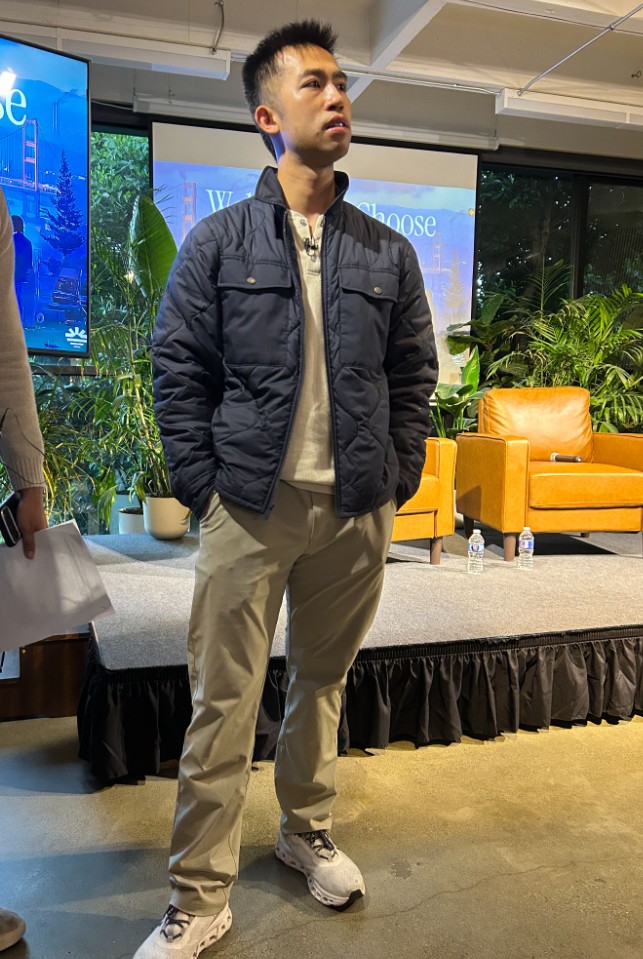 Jason Ma standing in front of the stage